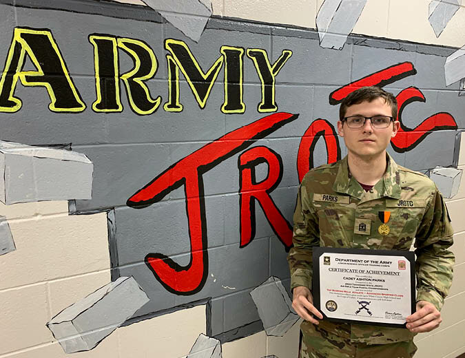 White County High School JROTC Cadet Ashton Parks holds one of the many certificates he has received for his skills in rifle marksmanship.